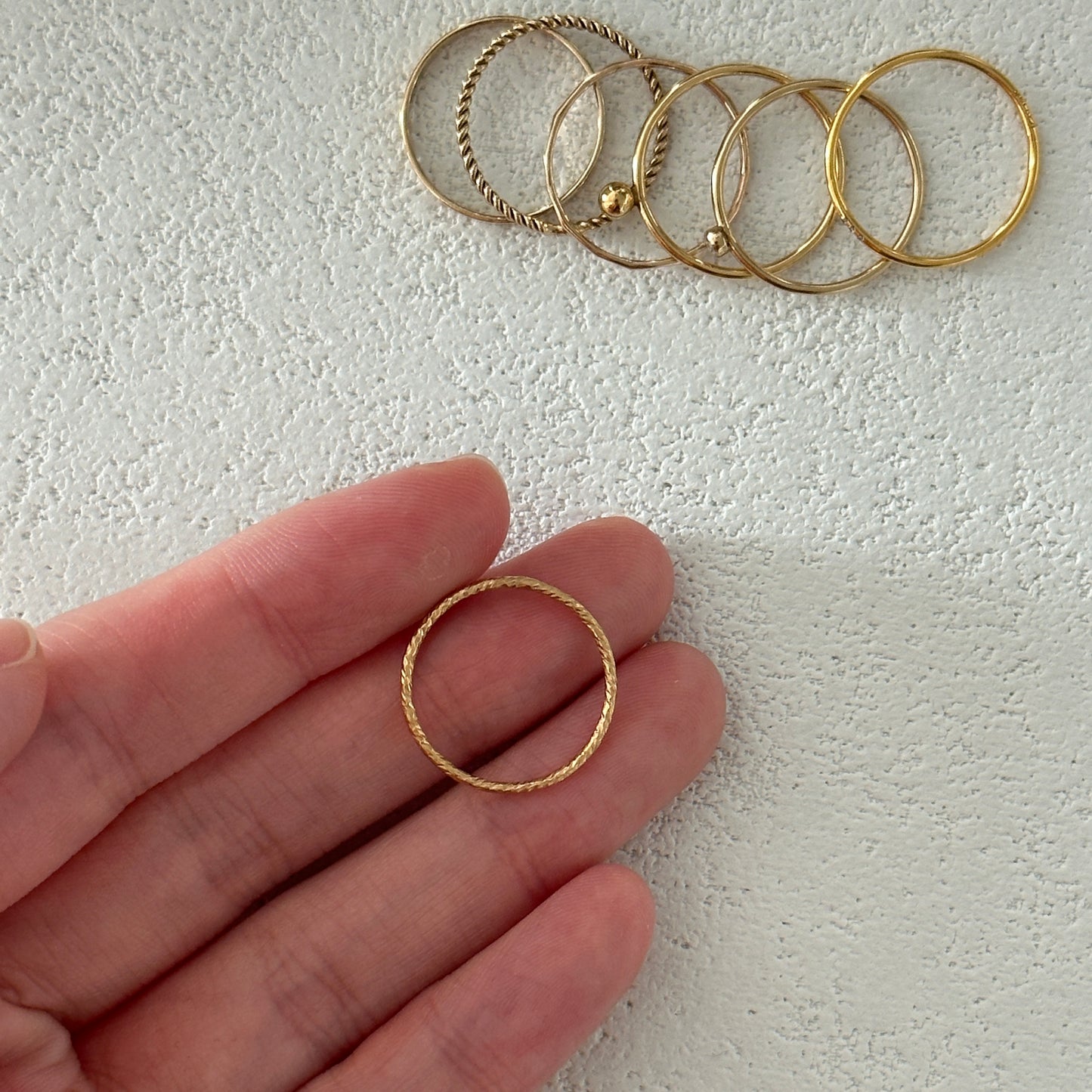 Minimalist gold stacking rings set on hand