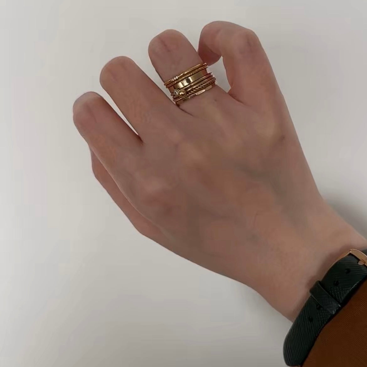 Elegant gold stacking rings on hand